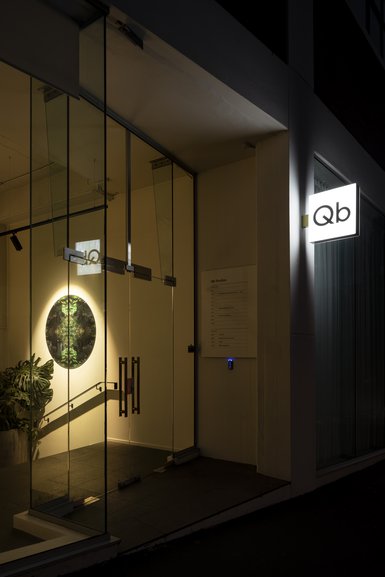 Glass entranceway with illuminated Qb sign
