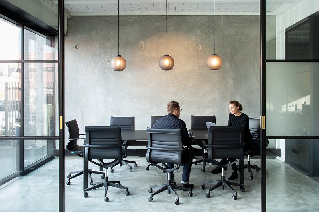 Man and woman in contemporary meeting space