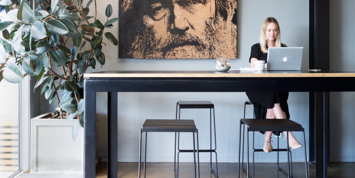 Woman working in communal space on laptop